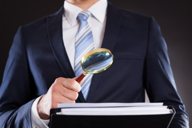 photodune-7783990-businessman-examining-documents-with-magnifying-glass-xs.jpg