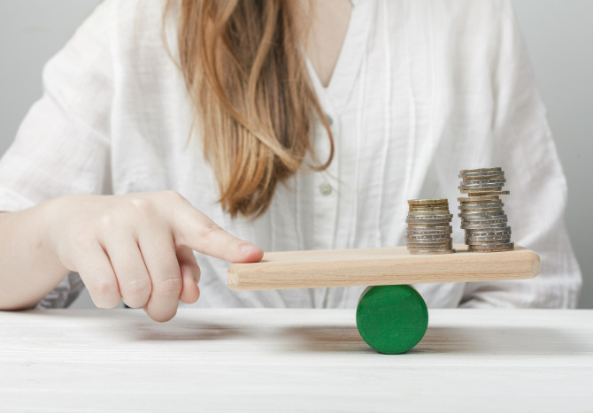 woman-holding-her-finger-balance-with-coins.jpg