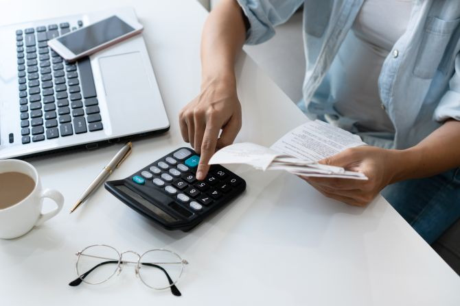 pretty-young-asian-woman-using-calculator-while-holding-bills-calculate-home-expenses-taxes-living-room-home.jpg