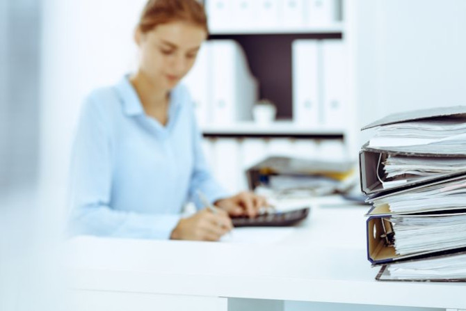 binders-with-papers-are-waiting-be-processed-by-business-woman-bookkeeper-back-blur-internal-audit-tax-concept.jpg