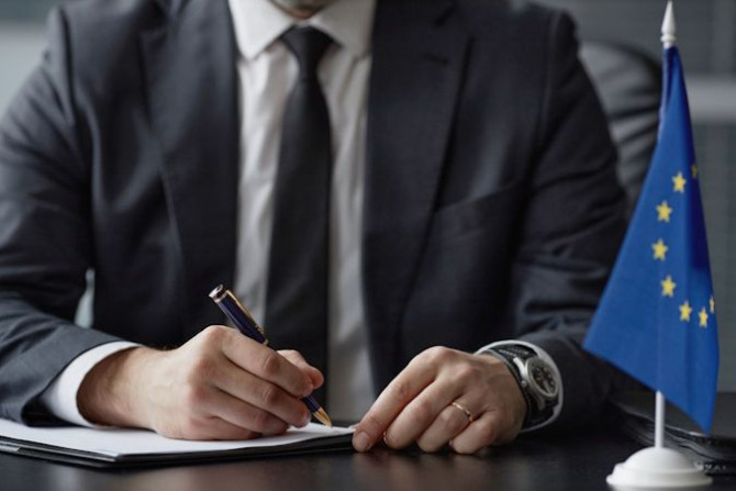 caucasian-middle-aged-male-politician-signing-documents-desk-office-desk.jpg