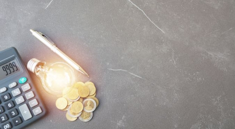 digital-composite-image-illuminated-light-bulb-by-coins-calculator-with-pen-table.jpg