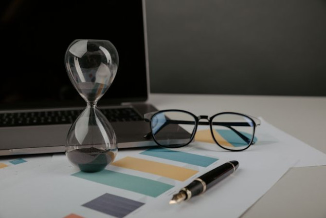 hourglass-workplace-with-reports-time-management-concept.jpg
