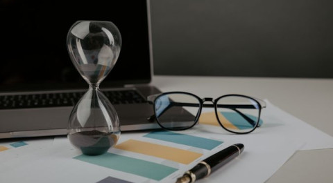 hourglass-workplace-with-reports-time-management-concept.jpg