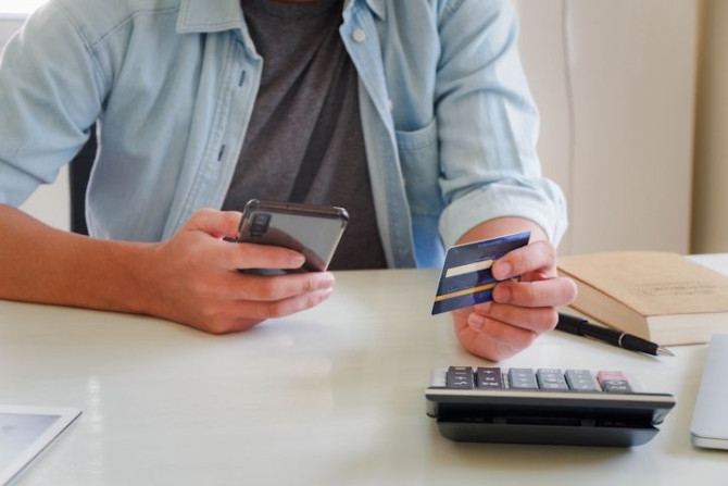 midsection-man-using-mobile-phone-table.jpg