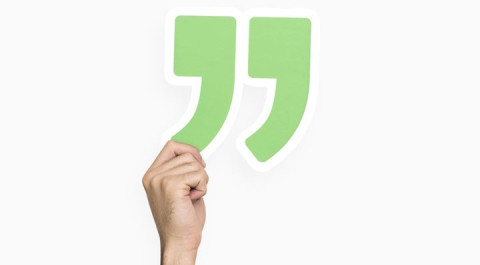 hand-holding-quotation-mark.jpg
