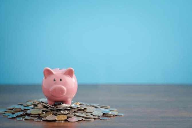 saving-invest-concept-pink-piggybank-with-jar-coins-dollar-bills.jpg