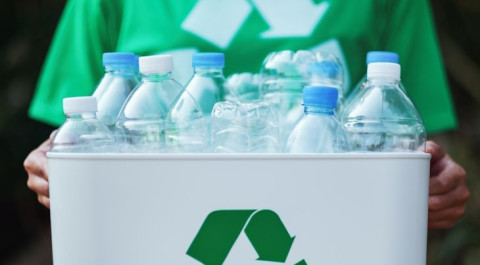 woman-collecting-garbage-holding-recycle-bin-with-plastic-bottles-outdoors.jpg