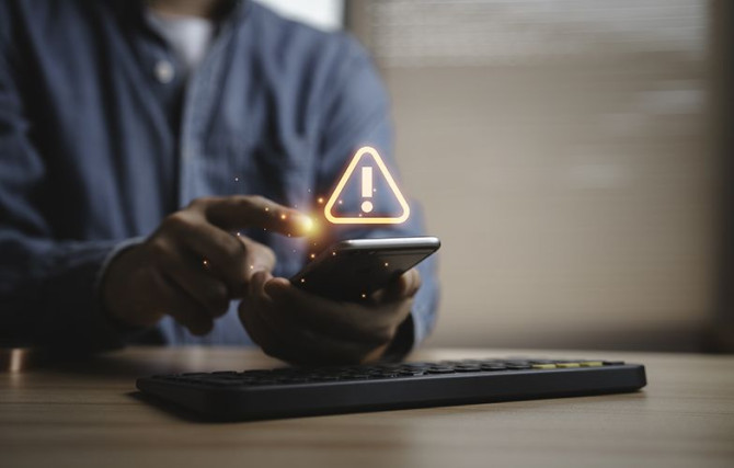 person-using-smartphone-with-warning-alert.jpg