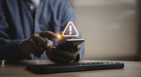 person-using-smartphone-with-warning-alert.jpg
