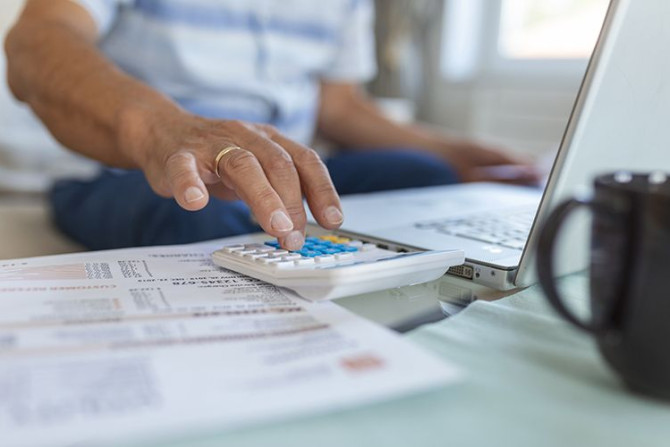 serious-elder-senior-greyhaired-grandpa-using-calculator-counting.jpg