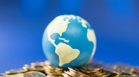 close-up-mini-world-ball-pile-gold-coins.jpg